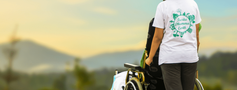 Carer pushing a wheelchair - respite for special needs child