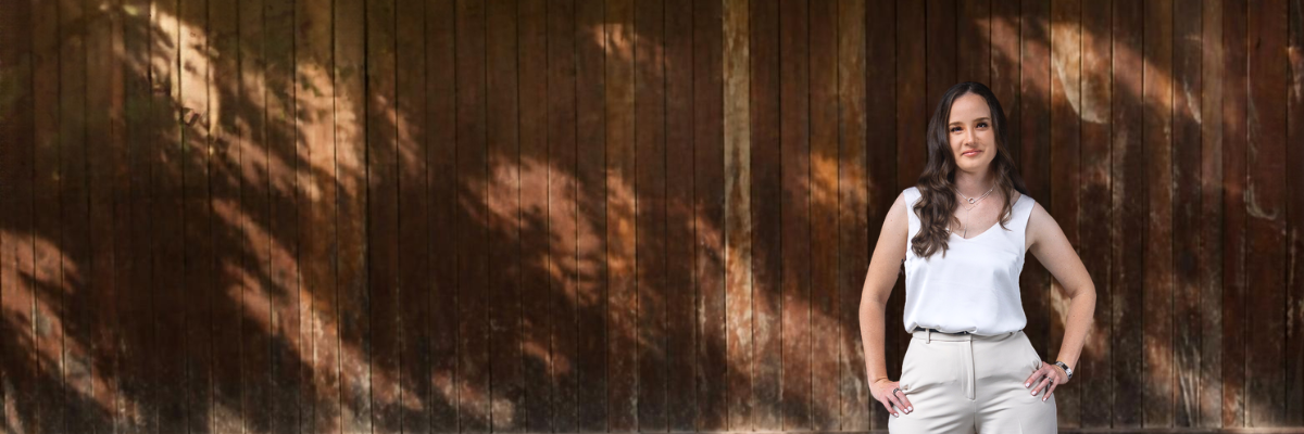 Abigail Burton against a dark timber background